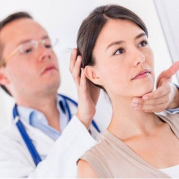 Der Neurologe untersucht einen Patienten, der Nackenschmerzen hat.